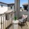 a balcony with a table chair and a railing